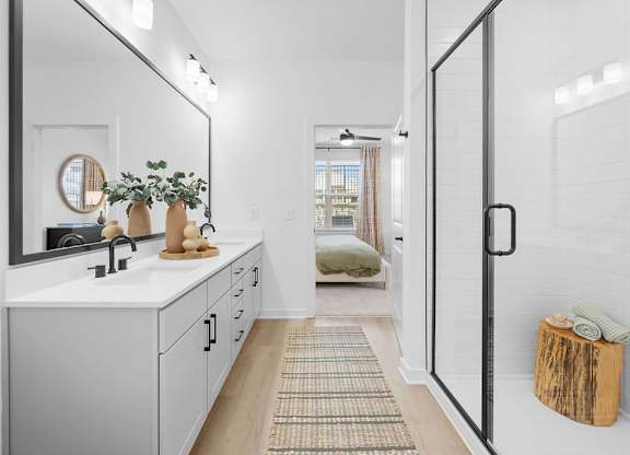 A bathroom with a white sink and a mirror above it.