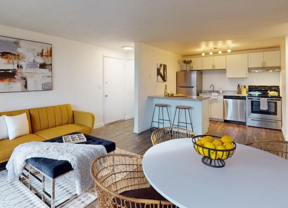 a living room with a white table and a kitchen