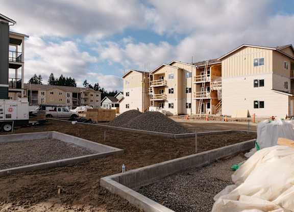 A construction site with a building under construction in the background.