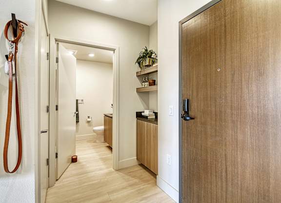 a hallway with wooden floors and a wooden door