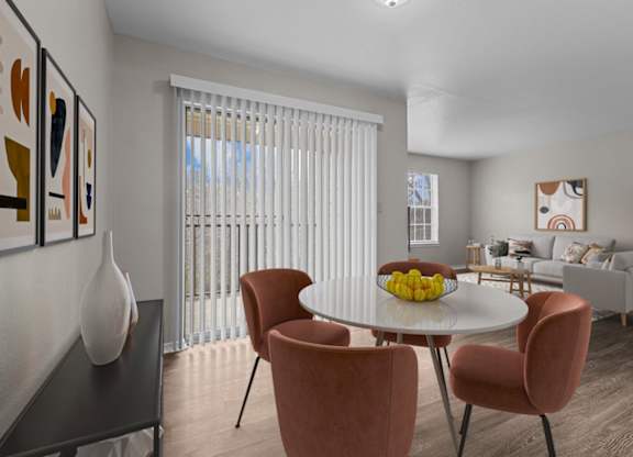 A dining room with a table set for four.