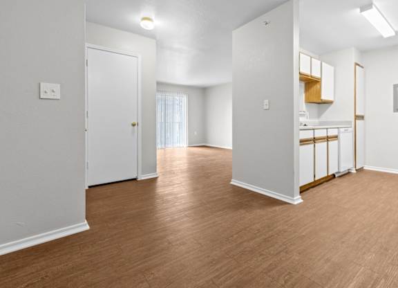 A room with wooden floors and white walls.