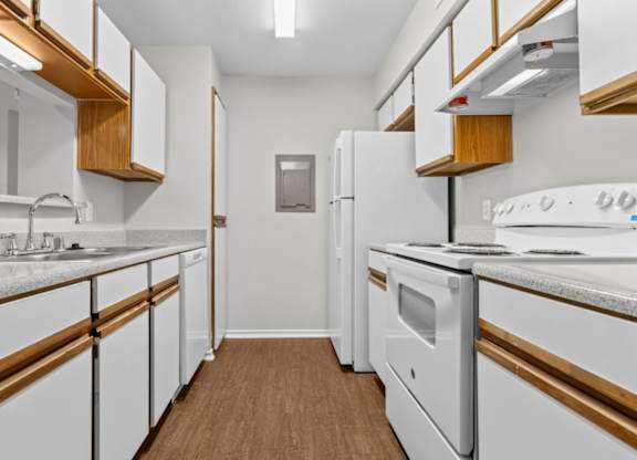 A kitchen with white appliances and wooden accents.