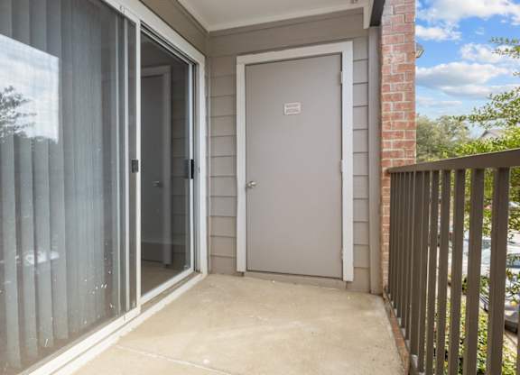 A white door is on the side of a house.