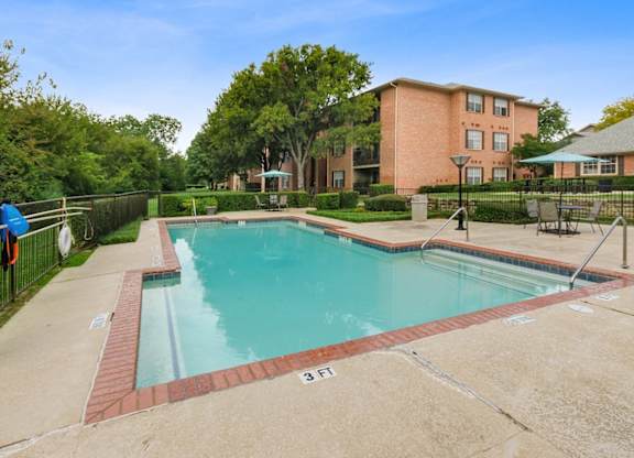A swimming pool surrounded by a brick border with a number 3 on it.