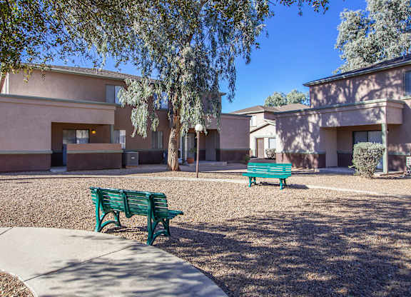 A green bench is in front of a building.