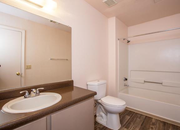 A white toilet sits next to a sink in a small bathroom.