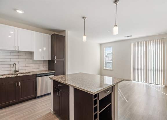 A kitchen with a large island and modern appliances.