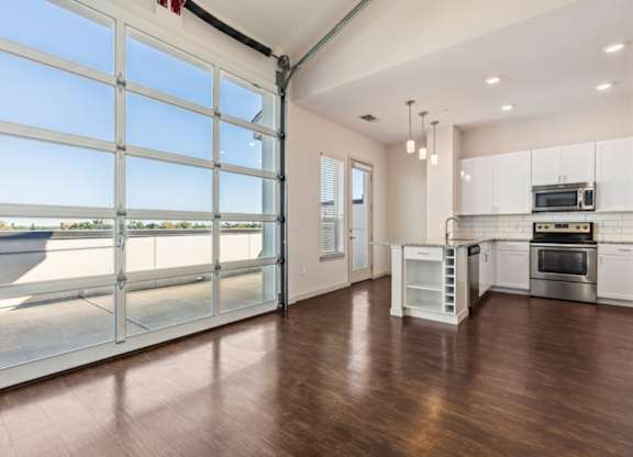 A spacious kitchen with a large window and a view of the outdoors.