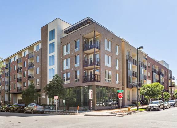 A large apartment building with a stop sign in front of it.