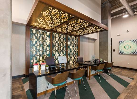 A conference room with a long table and chairs.
