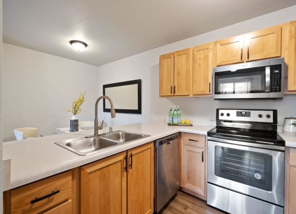 Kitchen with Dishwasher and View into Dining Room at The Crossings at Chapel Hill, Pasco