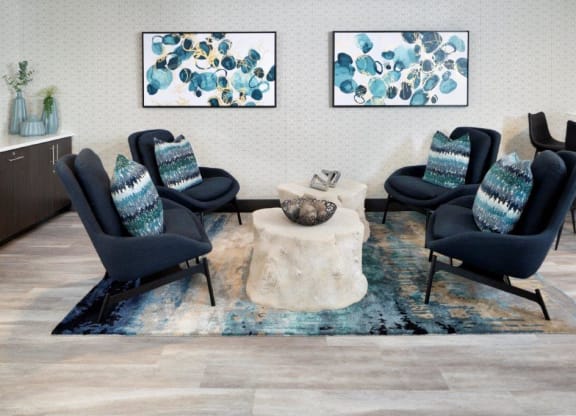 a living room with four chairs and a coffee table