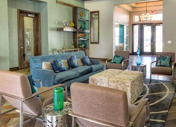 A living room with a blue couch and a coffee table.