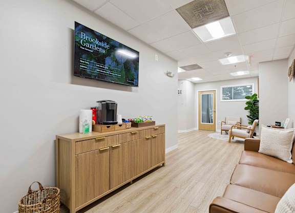 A living room with a flat screen TV mounted on the wall.