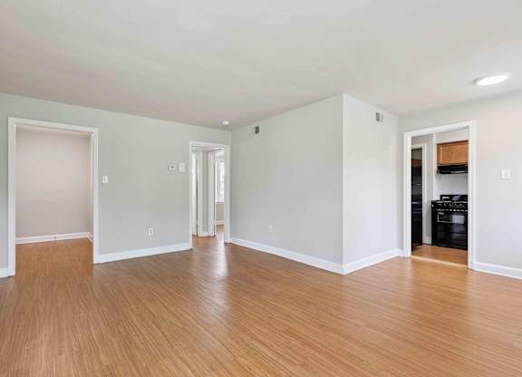 A room with wooden floors and white walls.
