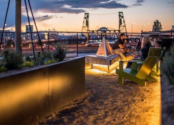 People Sitting Around Fire Pit at Yard Apartments