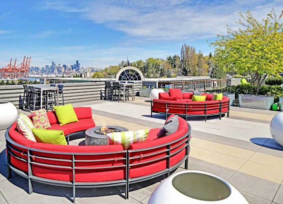 A red circular seating arrangement with a fire pit in the middle.