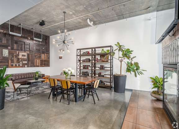 A modern dining room with a long table and chairs.