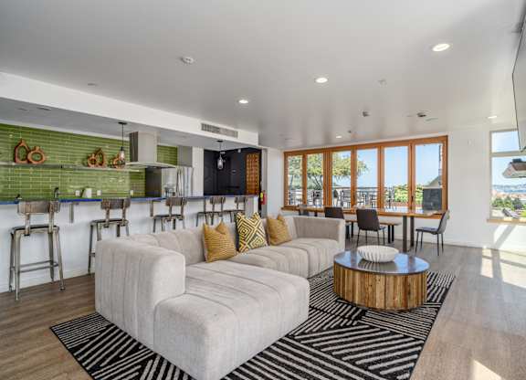 A living room with a white couch and a wooden coffee table.