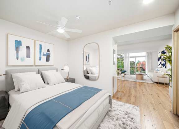 A bedroom with a large bed and a ceiling fan.