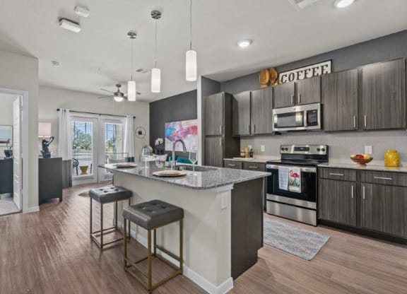 a kitchen with a large island with two stools