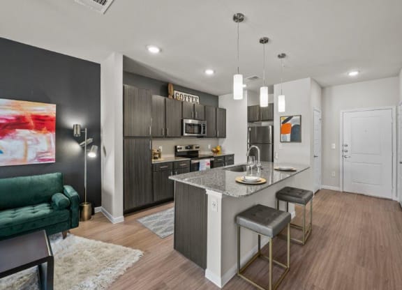 a kitchen and living room with a marble counter top