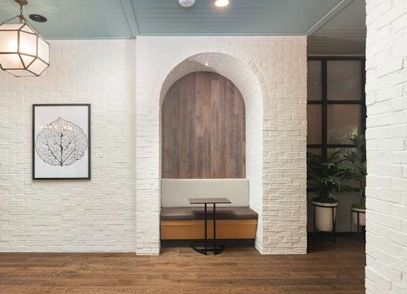 Private arched brick study area with small table and seating at Sylvan Uptown, Colorado, 80203