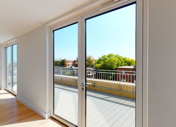 Living Room with Deck View at Saint James Place, Cambridge, MA 02140