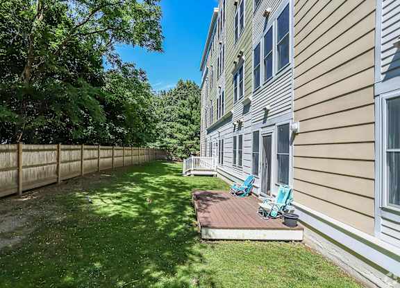 A sunny day at a residential area with a house and a fence at Park87 Apartments, Cambridge, Massachusetts