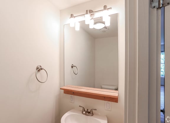 A bathroom with a white sink and a mirror above it at Park87 Apartments, Cambridge, MA, 02138