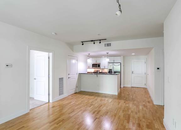 A kitchen with white cabinets and a wooden floors at 7 Cameron Apartments, Cambridge, Massachusetts