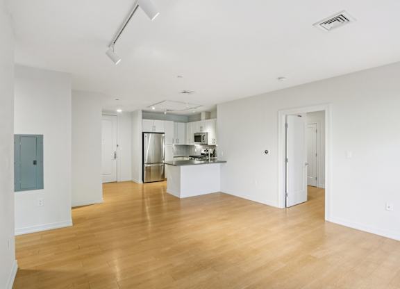 Unfurnished living room with kitchen view at Park77 Apartments, Cambridge, 02138
