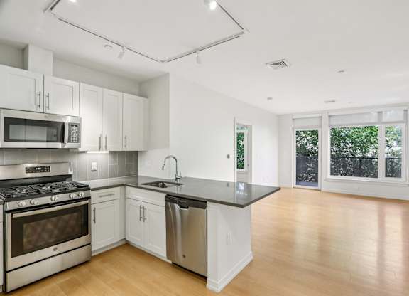 Kitchen with living room view at Park77 Apartments, Cambridge
