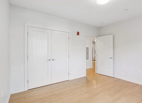 Spacious bedroom with wooden floor and closet at Park77 Apartments, Cambridge, MA