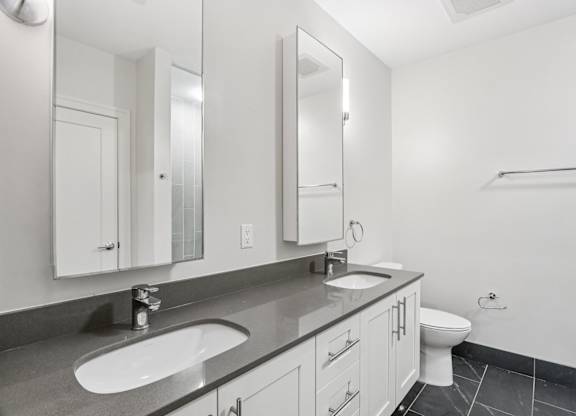 Bathroom with 2 sinks and mirrors and toilet at Park77 Apartments, Cambridge, Massachusetts, 02138