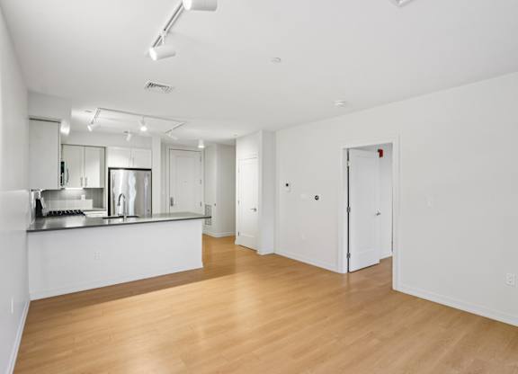 Spacious living room with kitchen view at Park77 Apartments, Cambridge, 02138