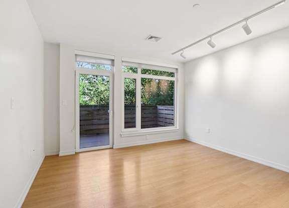 Living room with a sliding glass door at Park77 Apartments, Massachusetts