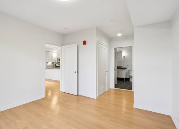 Bedroom with wooden floors and white walls  at Park77 Apartments, Cambridge, MA