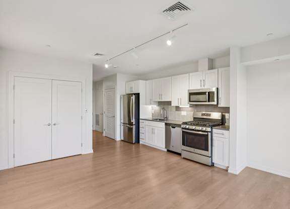 Kitchen with white cabinets and stainless steel appliances at Park77 Apartments, Cambridge, Massachusetts, 02138