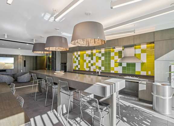 Modern kitchen with a yellow and green tiled backsplash at Park77 Apartments, Cambridge, MA, 02138