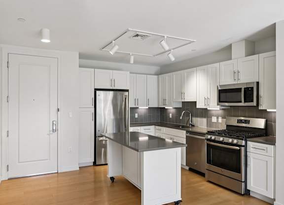 Beautifully decorated kitchen with white furniture at Park77 Apartments, Cambridge, 02138