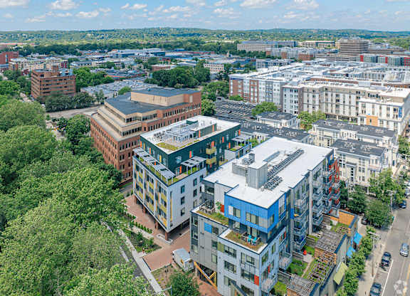 A cityscape with buildings and trees at 605 Concord at Fresh Pond Apartments, MA