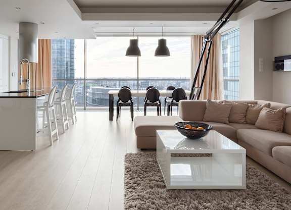 A modern living room with a large window overlooking the city.