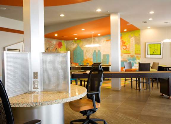 a dining area with tables and chairs and a mural on the wall