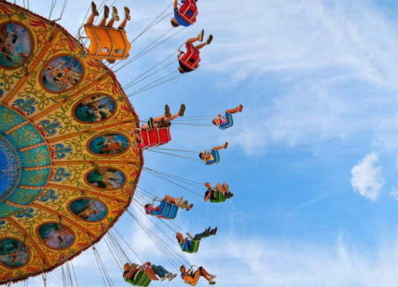 people riding on a ferris wheel at an amusement park