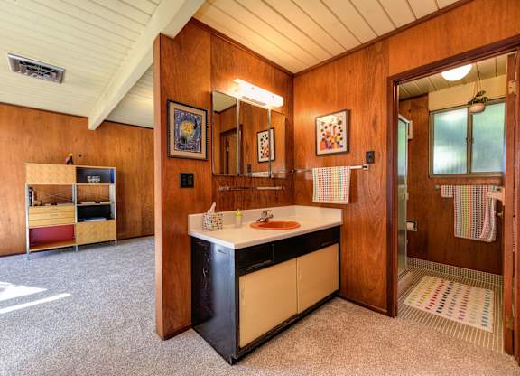 A kitchen area with a sink and a refrigerator.