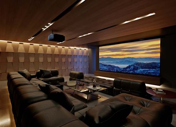 A modern home theater with a large screen and comfortable seating.