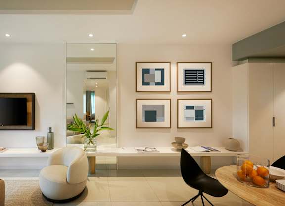 a living room with a desk and a television