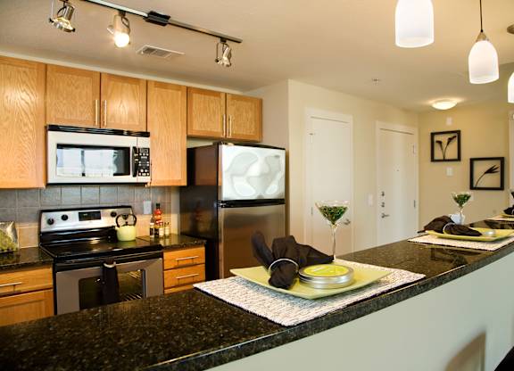 a kitchen with granite counter tops and stainless steel appliances